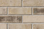 Briques en terre cuite de couleur beige avec des nuances brunes, disposées en motif de maçonnerie.