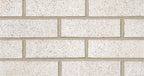 Mur de briques blanches avec des joints en ciment, texture lisse et légère variation de couleur.