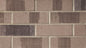 Briques en terre cuite de couleur beige et brun, disposées en motif rectangulaire sur un mur.