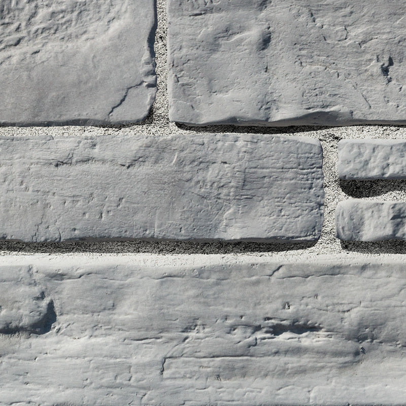 Pierre de béton grise pour revêtement de façade, aspect prestigieux et dynamique.