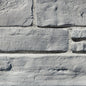 Pierre de béton grise pour revêtement de façade, aspect prestigieux et dynamique.