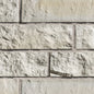 Mur en briques de couleur beige clair avec une texture rugueuse et des joints visibles entre les blocs.