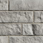 Pierre de béton architecturale grise avec texture contemporaine, idéale pour revêtement de façade.