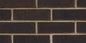 Briques en terre cuite de couleur brun foncé, disposées en motif de maçonnerie sur un mur.