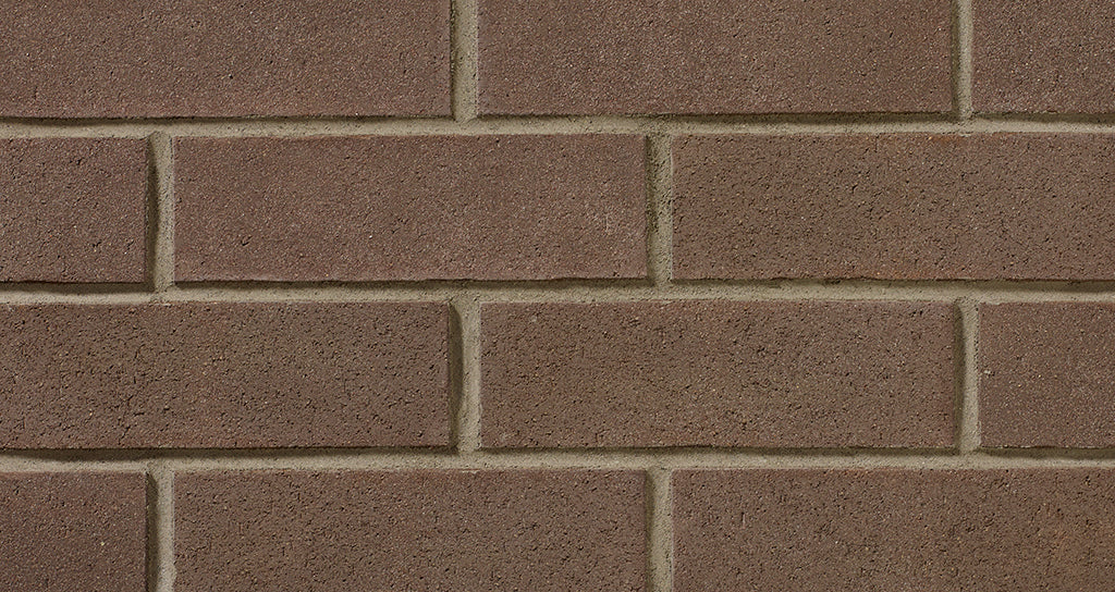 Mur de briques en argile, avec des joints clairs entre les briques, texture lisse et uniforme.