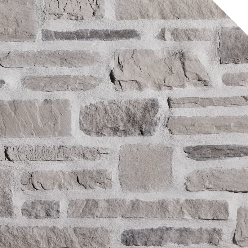 Mur en pierre grise avec des textures variées, incluant des blocs de différentes tailles et formes.