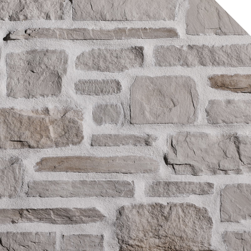Mur en pierre grise avec des blocs de différentes tailles et textures, créant un motif de maçonnerie.