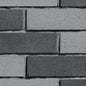 Briques en béton gris foncé et gris clair disposées en motif de maçonnerie. Texture rugueuse et finition mate.
