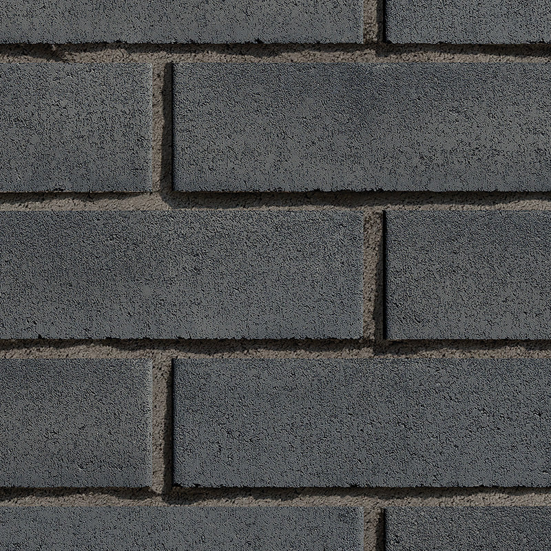 Mur de briques en béton gris foncé, avec une texture rugueuse et des joints visibles entre les briques.