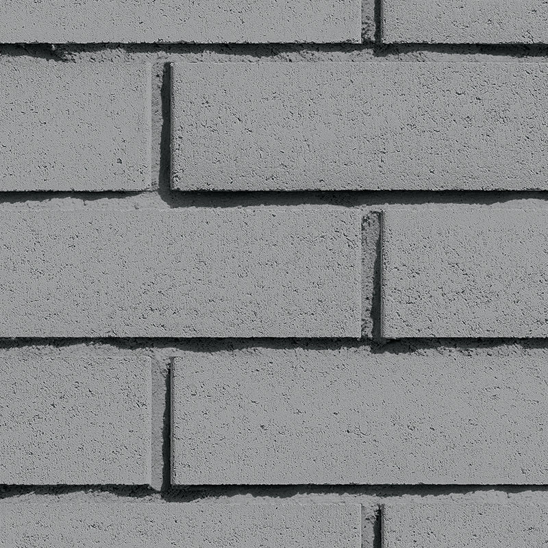 Mur de briques grises en béton, avec une texture lisse et des joints visibles entre les briques.