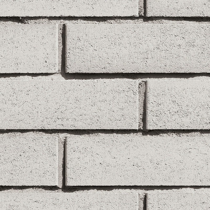 Mur en briques grises, texture lisse, alignement régulier, sans motifs visibles.