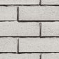 Mur en briques grises, texture lisse, alignement régulier, sans motifs visibles.