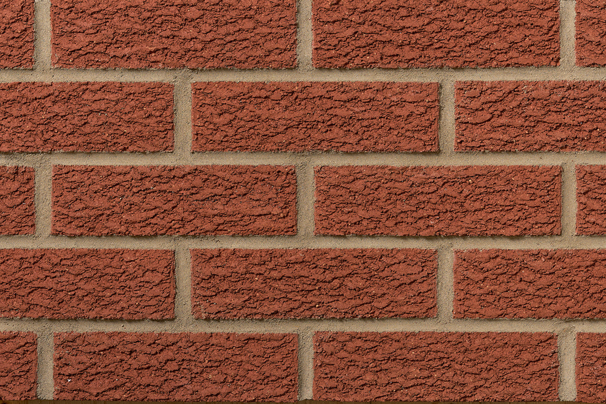 Mur en briques rouges avec une texture rugueuse, disposées en rangées régulières.