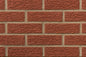Briques d'argile de couleur rouge, disposées en rangées avec des joints beige.