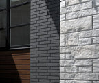 Mur en briques grises à surface lisse, dans un cadre moderne.