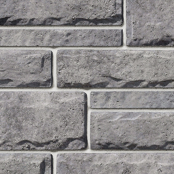 Pierre de béton grise avec texture légèrement ciselée, idéale pour revêtement de façade.