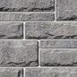 Pierre de béton grise avec texture légèrement ciselée, idéale pour revêtement de façade.
