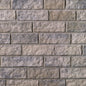 Mur en briques de couleur grise, avec une texture rugueuse et des joints visibles entre les briques.