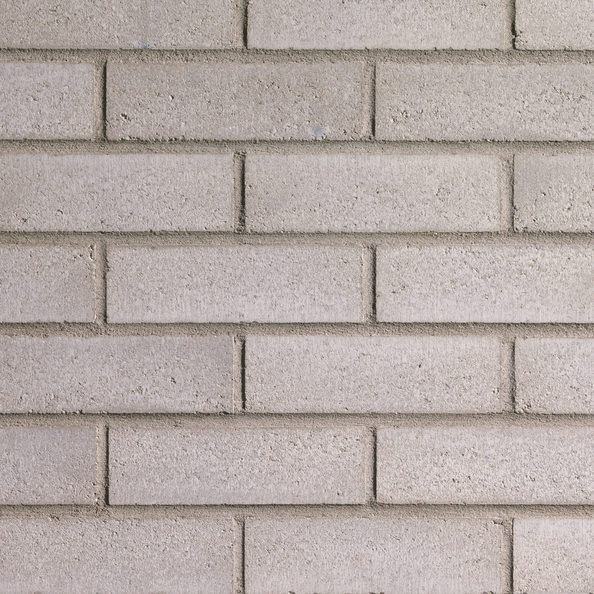 Brique Melville Slik® grise avec une surface lisse et des arêtes vives.