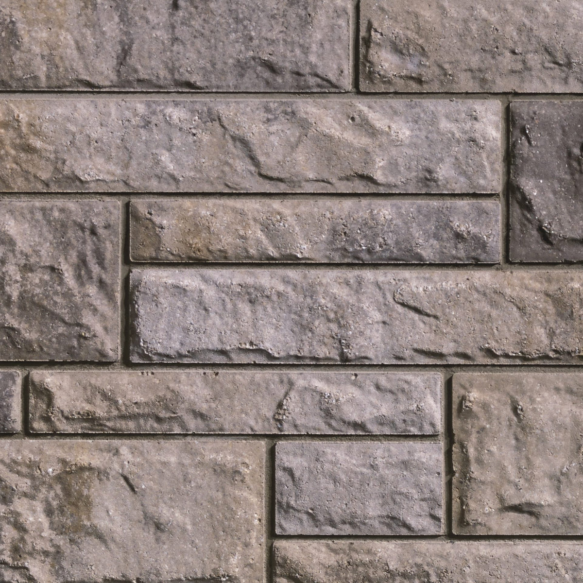 Mur en briques grises avec texture rugueuse, disposées de manière uniforme, créant un motif de maçonnerie.