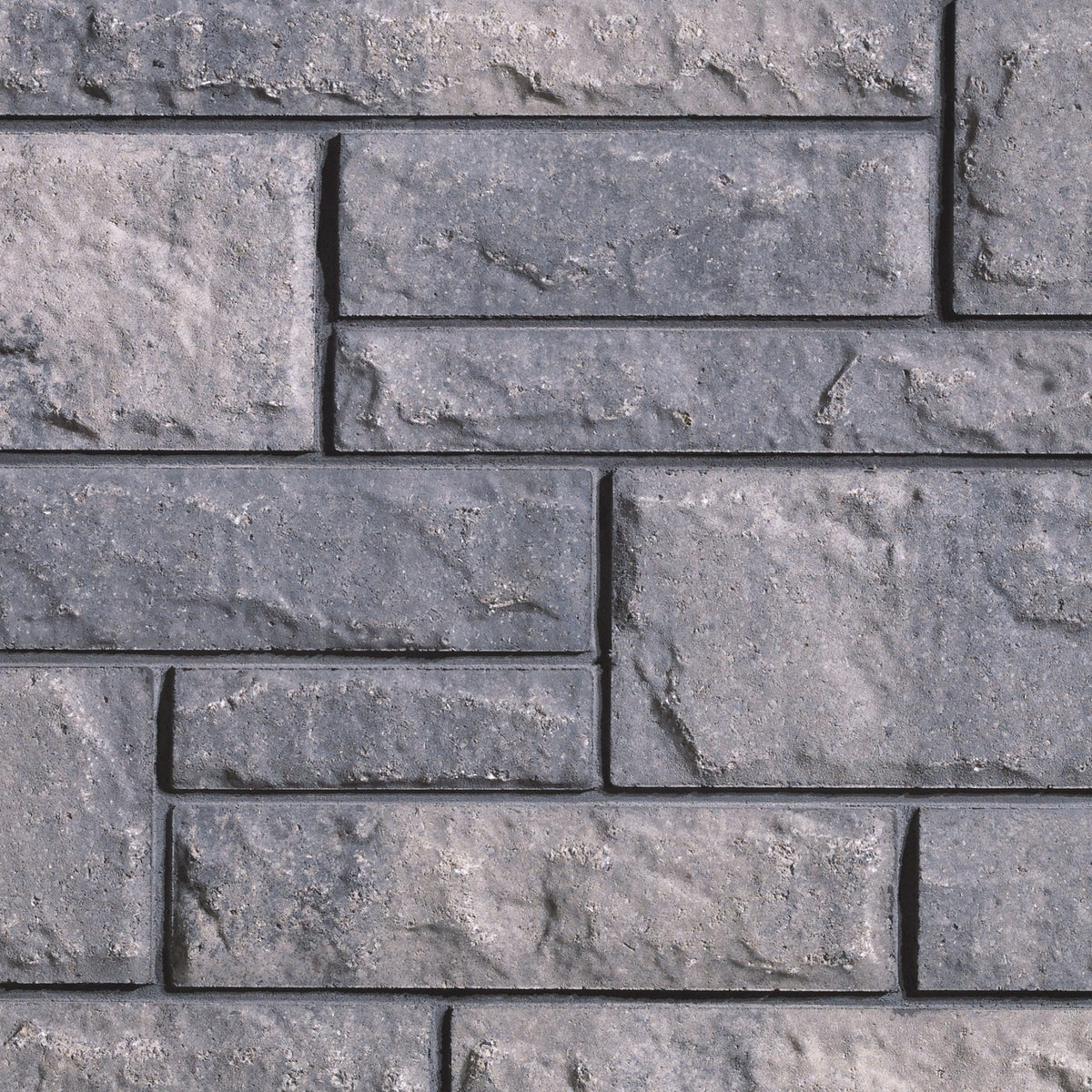 Mur de briques en béton gris, avec une texture rugueuse et des joints visibles, disposé en motif rectangulaire.